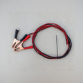 Jumper cables with red and black wires on a gray surface