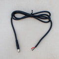 Black electrical cable with plug on a light gray background