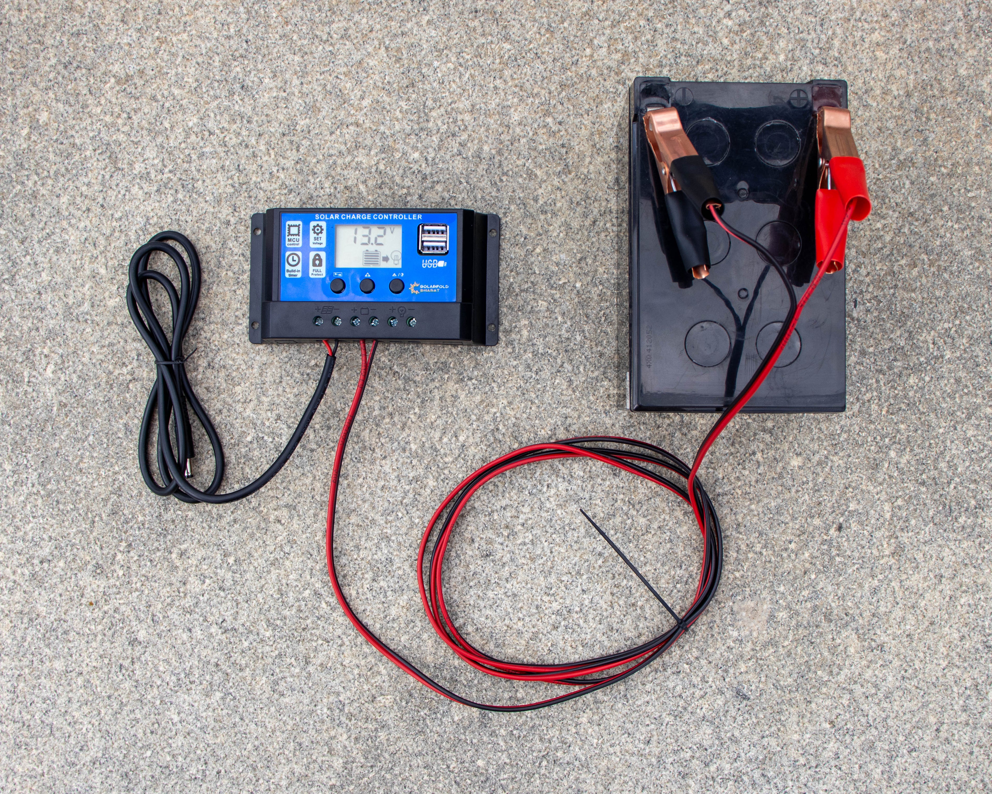 Battery charger and battery on a concrete surface