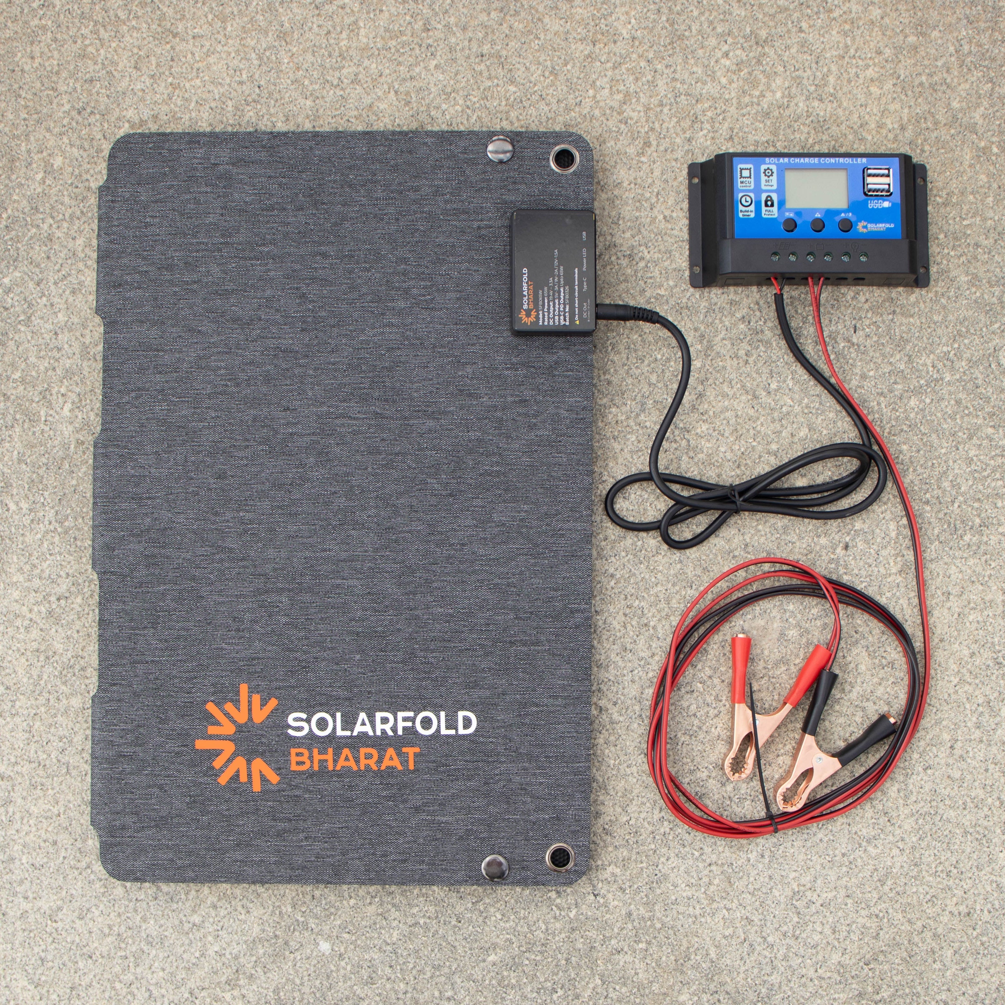 Solar panel with cables and battery on a gray surface