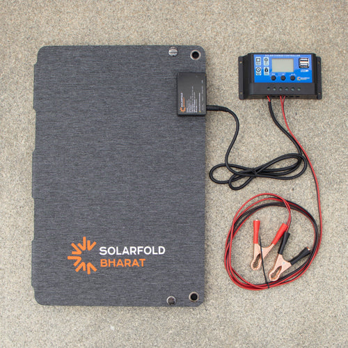 Solar panel with cables and battery on a gray surface